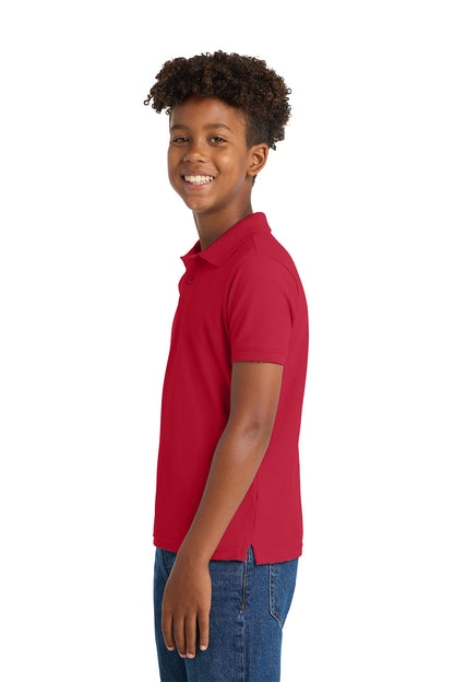 Child wearing a red polo shirt on a white background. Port Authority® Youth Core Classic Pique Polo, Embroidered by Helmsman Stitch Co.