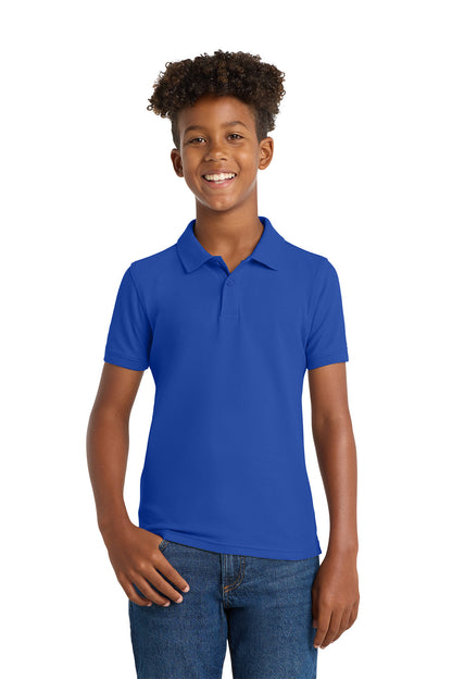 Person wearing a blue polo shirt on a white background. Port Authority® Youth Core Classic Pique Polo, Embroidered by Helmsman Stitch Co.