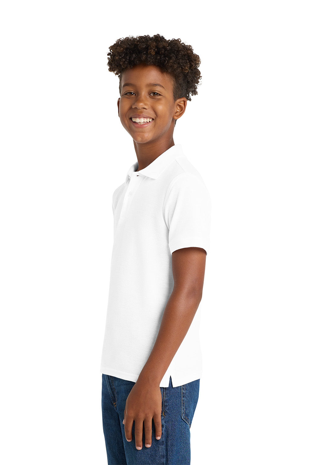 Young boy wearing a white polo shirt and blue jeans on a white background. Port Authority® Youth Core Classic Pique Polo, Embroidered by Helmsman Stitch Co.