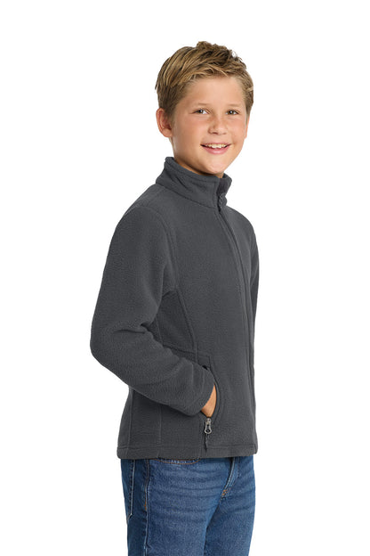 Young boy wearing a gray fleece jacket on a white background. Port Authority® Youth Value Fleece Jacket, Embroidered by Helmsman Stitch Co.