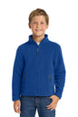 Young boy wearing a blue jacket on a white background. Port Authority® Youth Value Fleece Jacket, Embroidered by Helmsman Stitch Co.