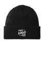 A black ribbed knit beanie hat with a white embroidered placeholder text reading 'YOUR LOGO HERE' on the front cuff, shown against a plain white background. Port Authority® Thermal Knit Cuff Beanie, Embroidered