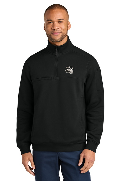 A man wearing a black quarter-zip pullover sweatshirt with a mock neck and a small black logo on the left sleeve, paired with navy blue pants, against a solid white background. CornerStone® 12-Oz. Tough Fleece Job Shirt, Embroidered