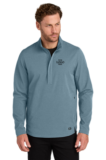 Man wearing a blue pullover with a logo on a white background. OGIO® Aspect 1/2-Zip Pullover, Embroidered by Helmsman Stitch Co.